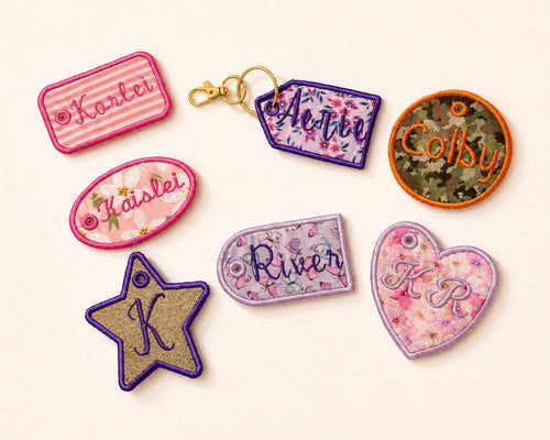 Seven decorative embroidered patches in various shapes (star, oval, rectangular, arch, price tag, heart, circle) with floral and striped patterns, displayed on a light cream background.