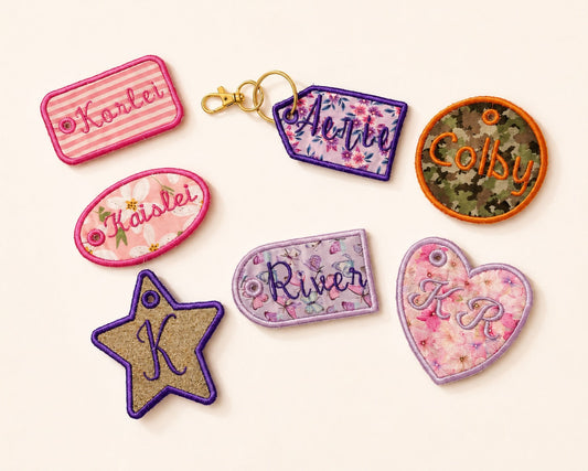 Seven decorative embroidered patches in various shapes (star, oval, rectangular, arch, price tag, heart, circle) with floral and striped patterns, displayed on a light cream background.